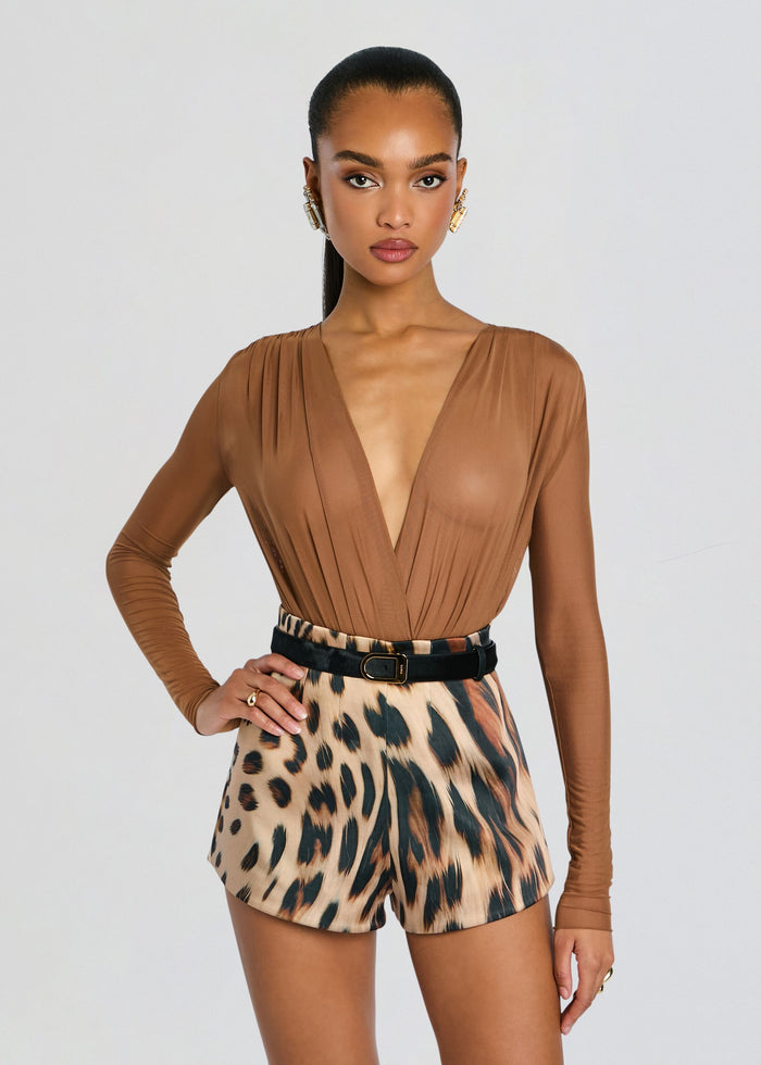 Tan Agnes Bodysuit with a plunging V neckline and pleated shoulder detail worn by a model. media 1 of 5