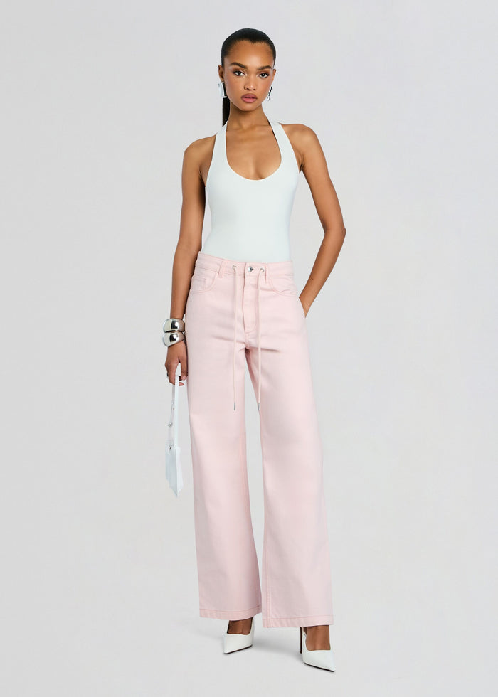 Model wearing pale pink Astrid Denim Pant with light blue halter top and white heels media 2 of 5