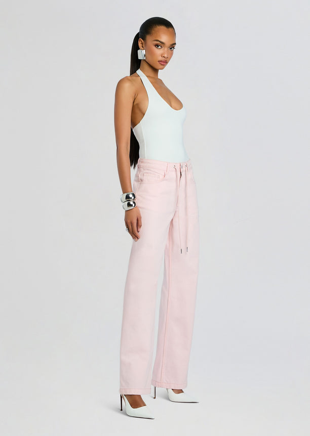 Astrid Denim Pant front view in pale pink wide-leg jeans paired with a light blue halter top