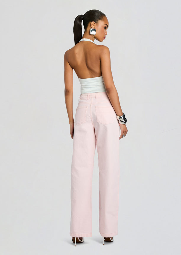 Back view of Astrid Denim Pant ensemble with pale pink wide-leg jeans and a light blue halter top