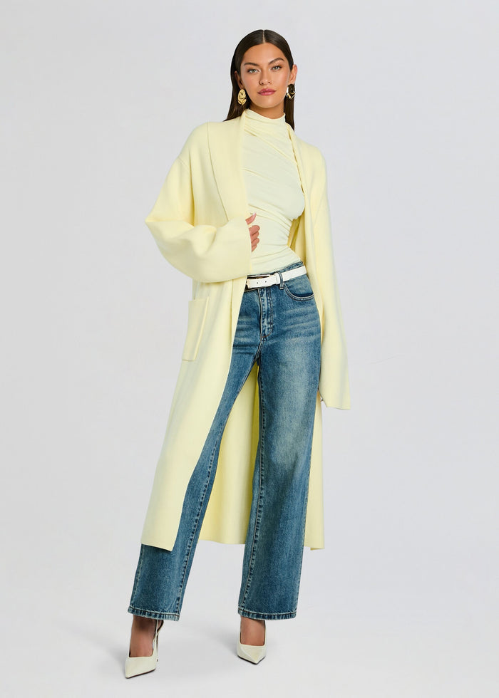 Crosby Sweater Duster worn open over a pale yellow turtleneck, paired with jeans and a white belt. media 1 of 5
