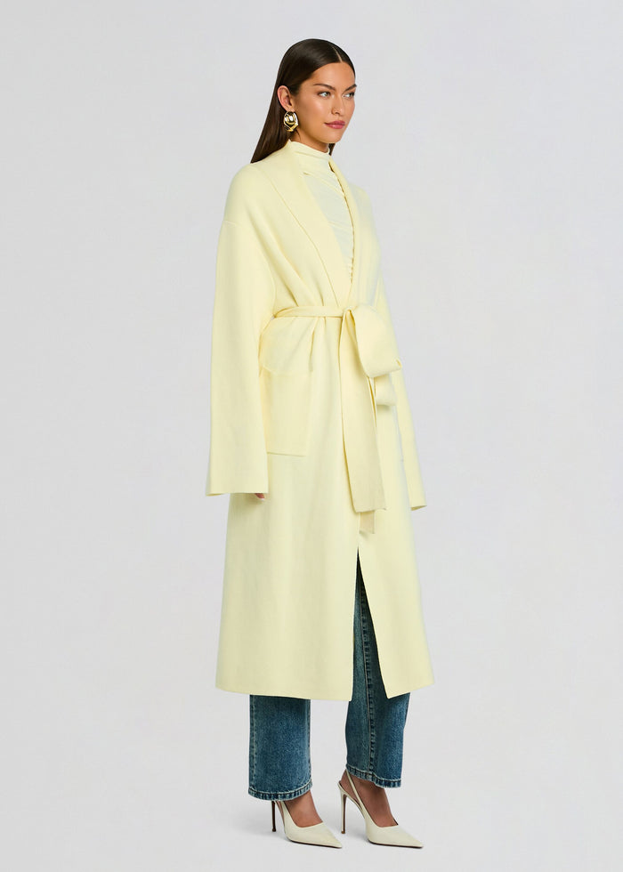 Crosby Sweater Duster pale yellow shown in a three quarter view with belt tied at the waist over jeans media 4 of 5