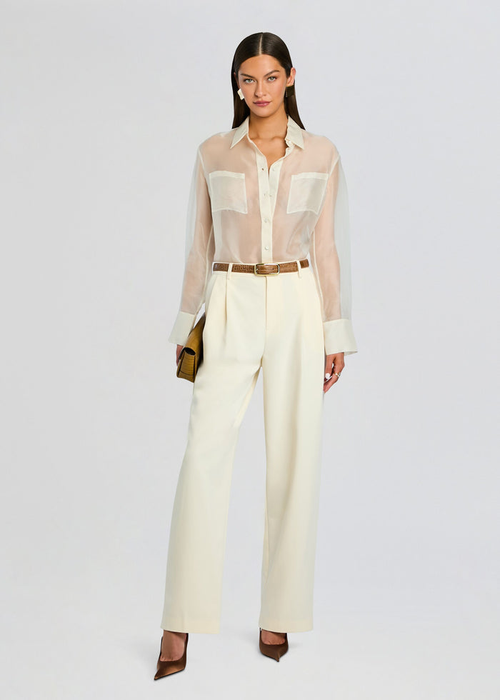 Full-length look of Estella Silk Top tucked into ivory wide-leg pants with a brown belt and clutch. media 2 of 5