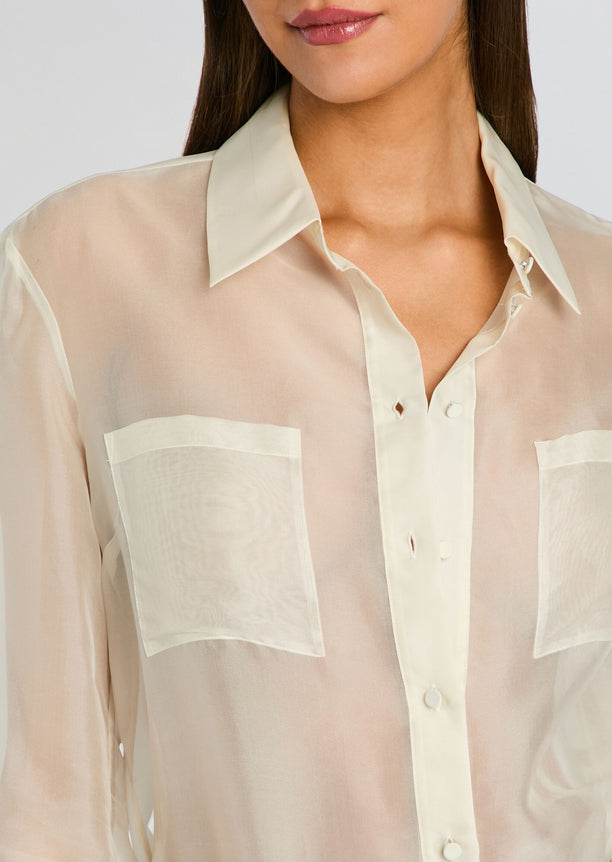 Close-up of sheer cream Estella Silk Top showing a pointed collar and two front pockets.