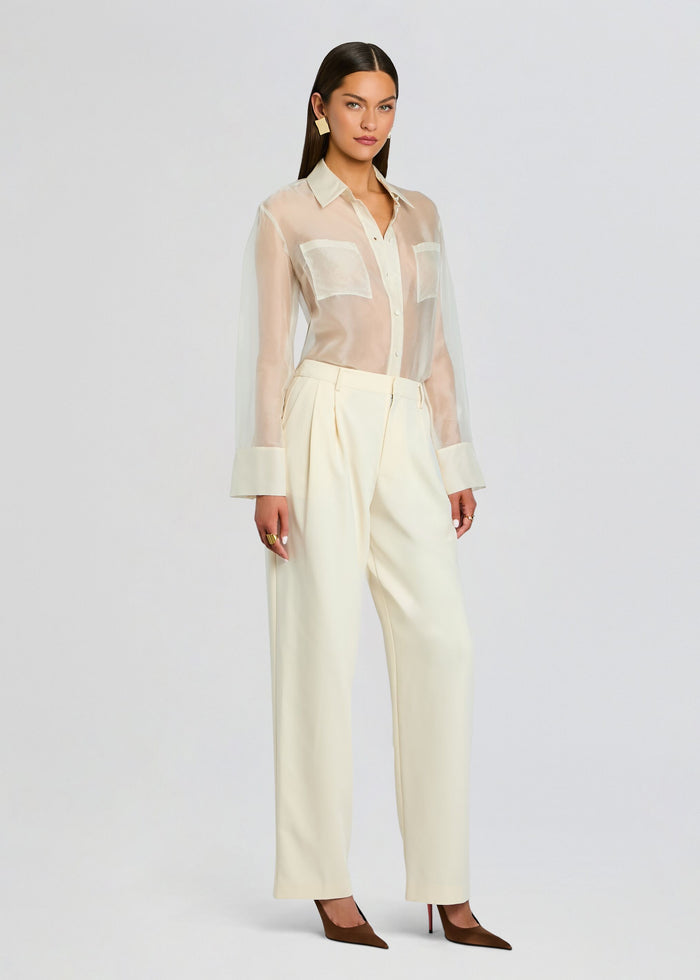 Full-length model wearing the Sonya Pant outfit with a sheer cream blouse tucked into cream wide-leg pants and brown heels. media 4 of 5