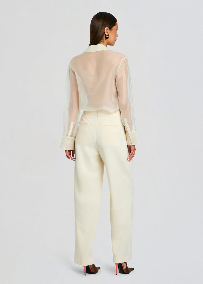 Back view of a model wearing ivory Sonya Pant with back pockets and wide legs. media 5 of 5