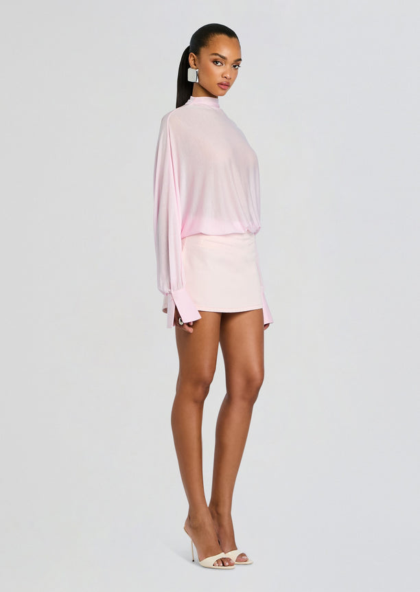 Model wearing Miya Denim Mini Skirt in pale pink with matching top and nude heels