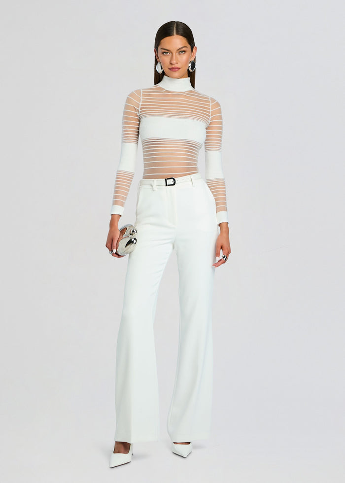 Katrine Top styled with white wide leg pants a white belt and a small silver round clutch media 2 of 5