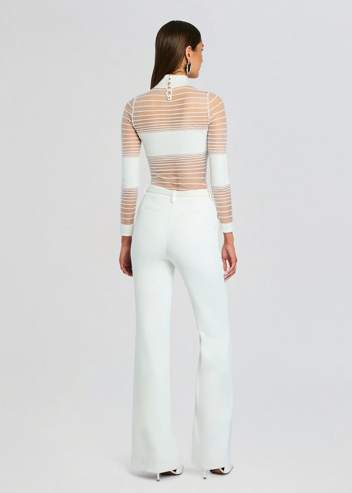 Back view of Katrine Top showing sheer striped mesh with white underlayer and white high waisted pants media 5 of 5