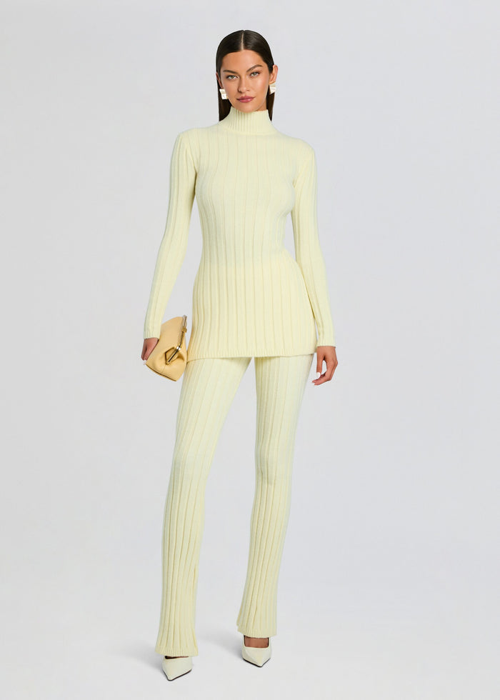 Full body view of pale yellow Velira Knit Pant set with matching ribbed top and white heels. media 2 of 5