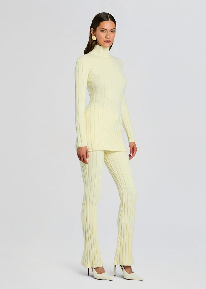 Full-length model wearing the pale yellow Velira Knit Pant set with matching ribbed knit top media 4 of 5
