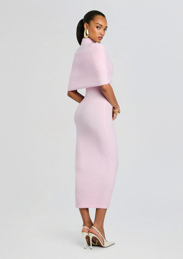 Side view of a model in a pale pink Wisteria Knit Midi Dress with a capelet over the shoulders.