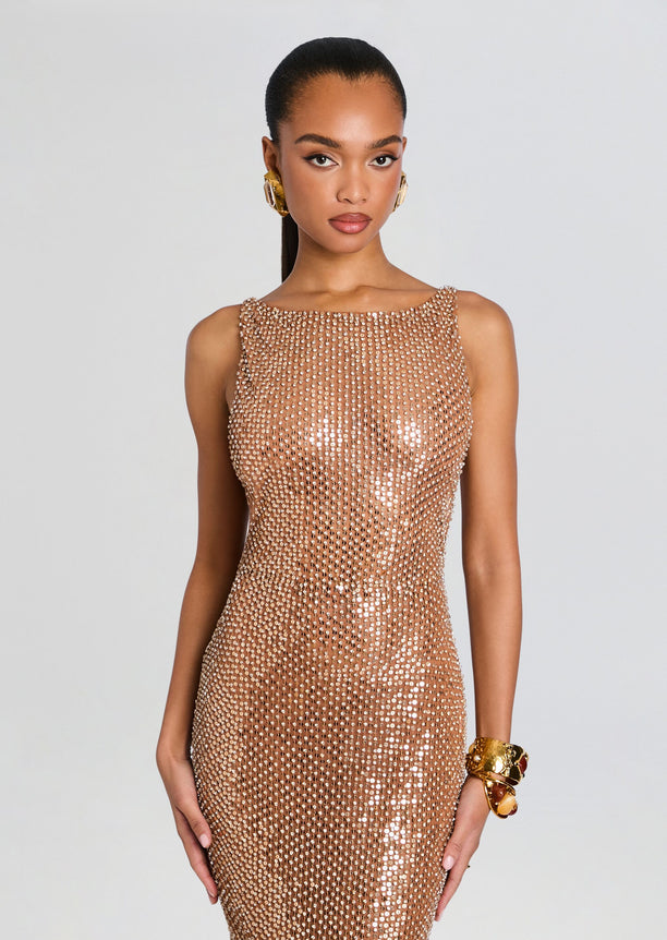 Model wearing Asha Sequin Dress, champagne sequin bodycon gown with sleeveless design.