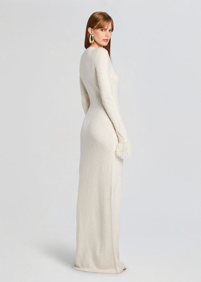 Side view of ivory Carina Maxi Dress showing a fitted silhouette and fringe cuff details. media 4 of 5