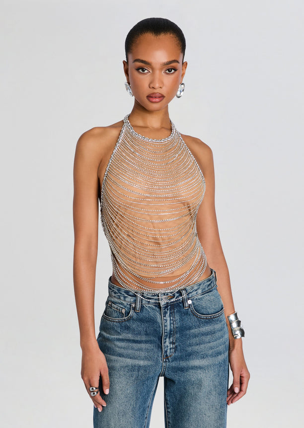 Model wearing a Delaney Embellished Top with cascading silver beaded chains over a nude base, paired with blue jeans.