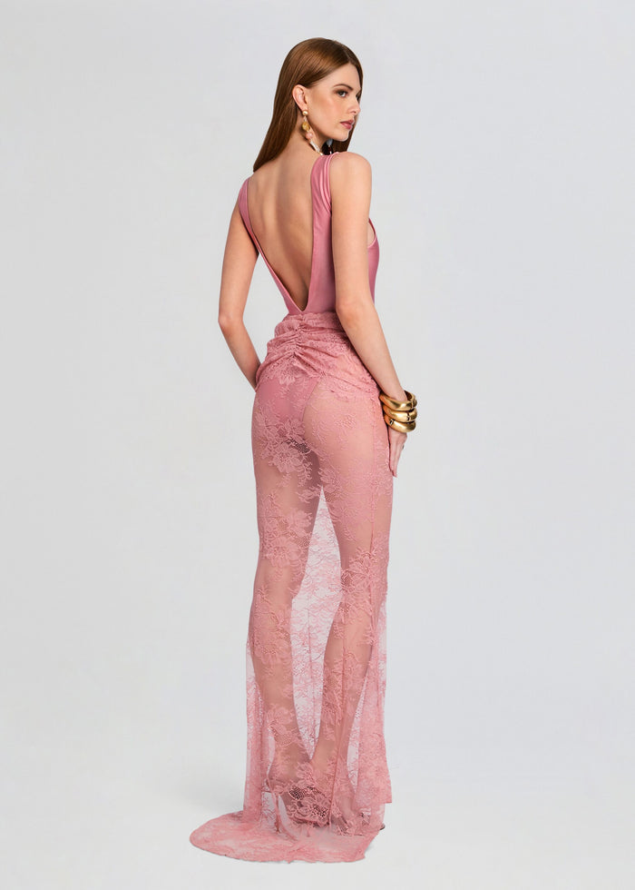 Side view of a model in a pink Brenda Maxi Skirt with lace overlay and open back bodice. media 5 of 5