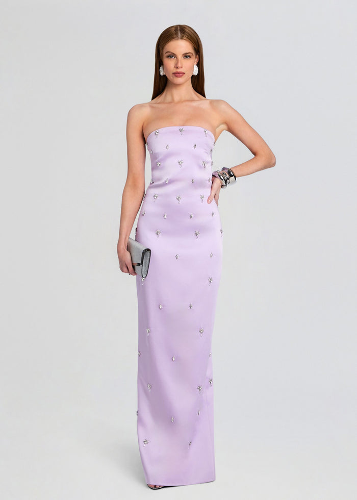 Model wearing a lavender strapless Keziah dress with crystal embellishments and a silver clutch media 1 of 5