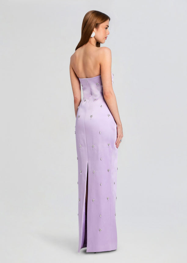 Back view of lavender strapless embellished dress with crystal accents and a back slit.