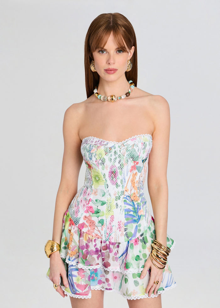 Model wearing a strapless Sora Short Dress with white lace trim and a colorful floral print. media 5 of 5