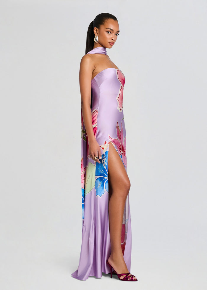 Side view of a model wearing lavender Tizzy Silk Dress with vibrant floral print and high slit media 3 of 6