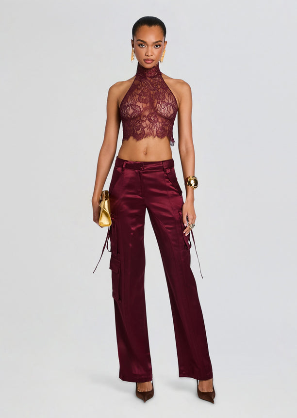 Violet Lace Top burgundy lace halter crop with matching satin pants, gold jewelry, and a gold clutch.