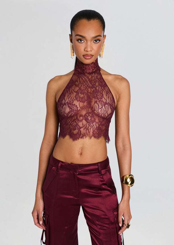 Violet Lace Top burgundy lace halter crop worn with matching satin pants and gold earrings.