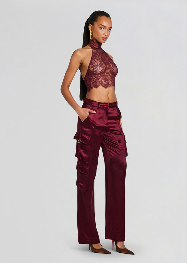 Model wearing Violet Lace Top with burgundy satin cargo pants facing the camera.