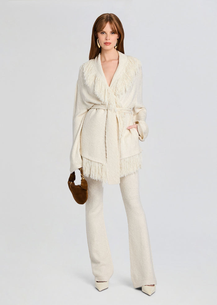 Full body view of model in cream Winslet Cardigan with fringe trim, matching pants, and a brown handbag. media 2 of 5