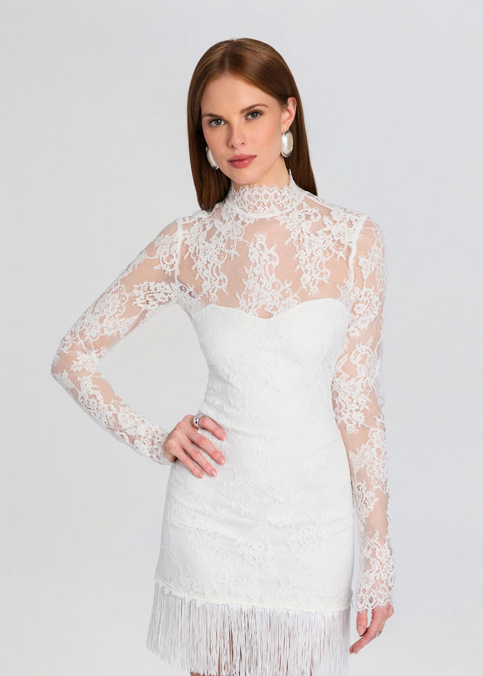 Three-quarter front view of Xylina Lace Dress with high neck and long sheer lace sleeves and fringed hem. media 5 of 5