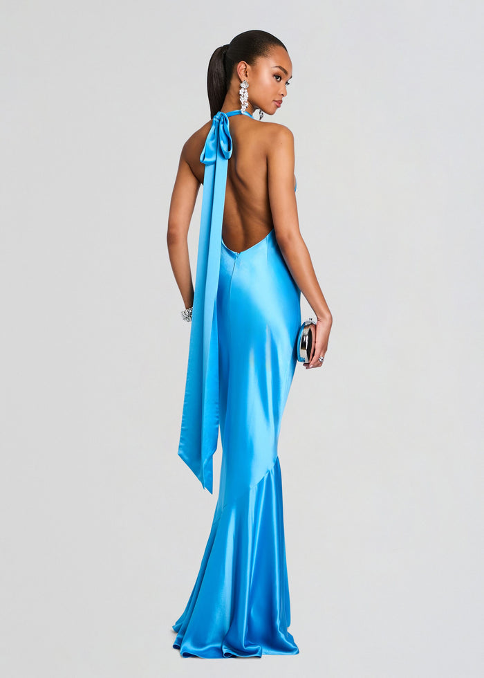 Back view of a bright blue satin Alison Dress with a long halter sash draped down the model's back media 5 of 6
