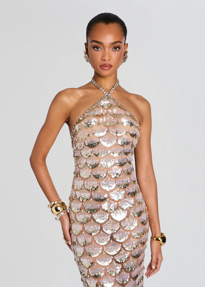 Model wearing a rose gold sequined halter dress with scalloped shell pattern and crystal embellishments media 5 of 5
