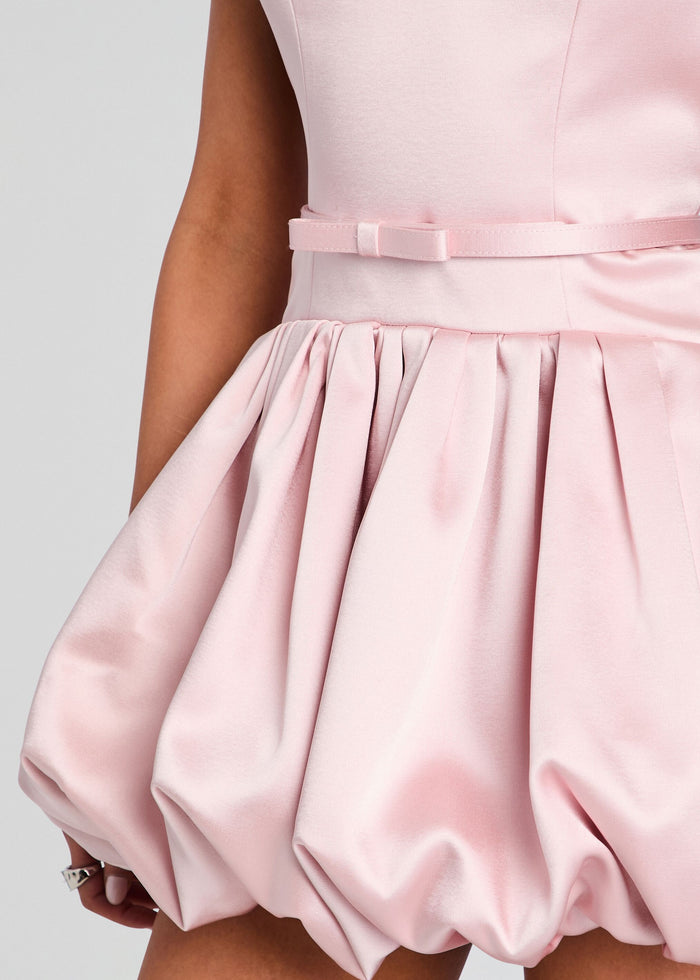 Close detail of pink satin Isolde Dress showing the waist belt and gathered bubble skirt. media 3 of 6