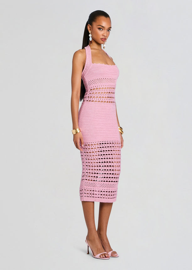 Full length side view of a model wearing a pink Jaycee Crochet Dress with a halter neckline and crochet panels