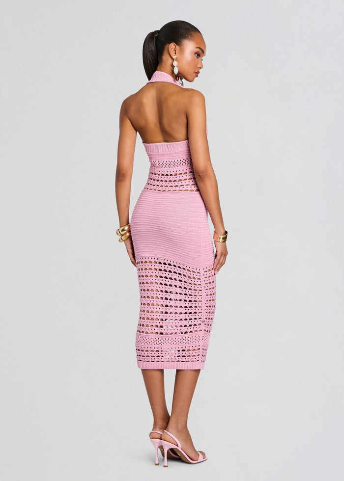 Back view of a model in a pink Jaycee Crochet Dress revealing an open back and fitted crochet detailing from waist to hem media 4 of 5