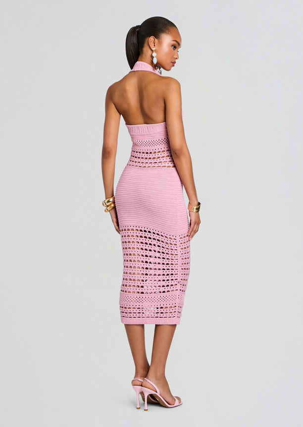 Back view of a model in a pink Jaycee Crochet Dress revealing an open back and fitted crochet detailing from waist to hem