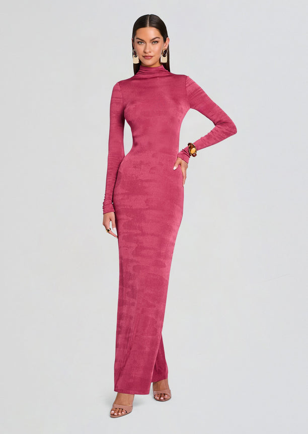 Full length view of a pink velvet maxi dress with a high neckline and long sleeves on a model.