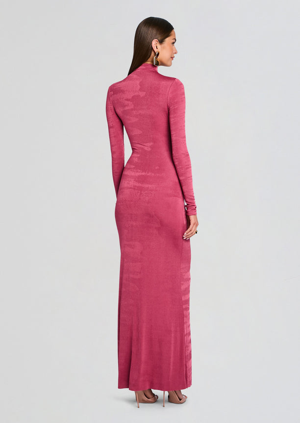 Back view of a model wearing a magenta Kim Maxi Dress with long sleeves and high neckline