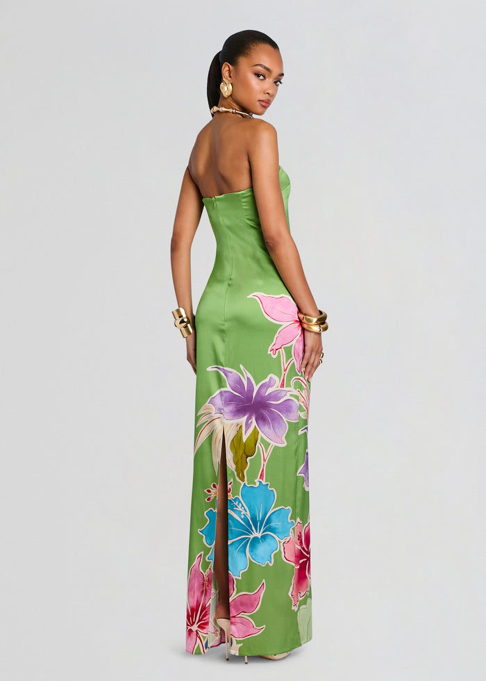Back view of a green Vivi Silk Dress with bold tropical flowers in pink purple and blue along the skirt. media 5 of 6
