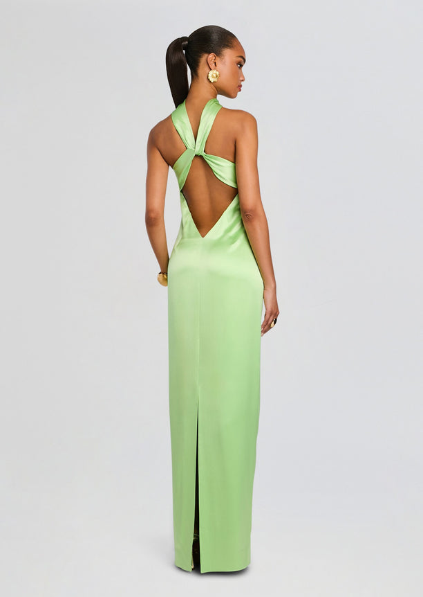 Back view of a lime green satin gown with a halter neckline and crisscross back straps forming a large open back.