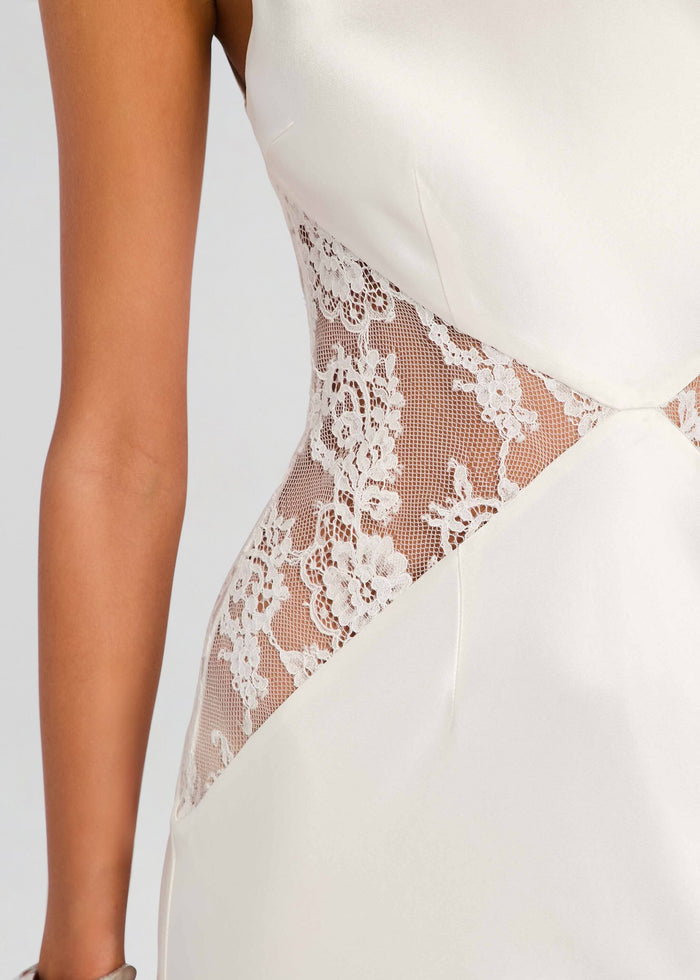 Close up of a white satin dress showing a sheer floral lace side panel media 3 of 6