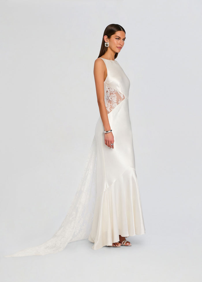 Model wearing white satin Analuisa Lace Dress in side profile with lace panel and long flowing skirt media 4 of 6