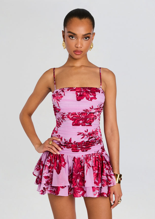 Anouk Dress front view featuring pink floral print, thin straps, fitted ruched bodice and a tiered ruffle mini skirt.