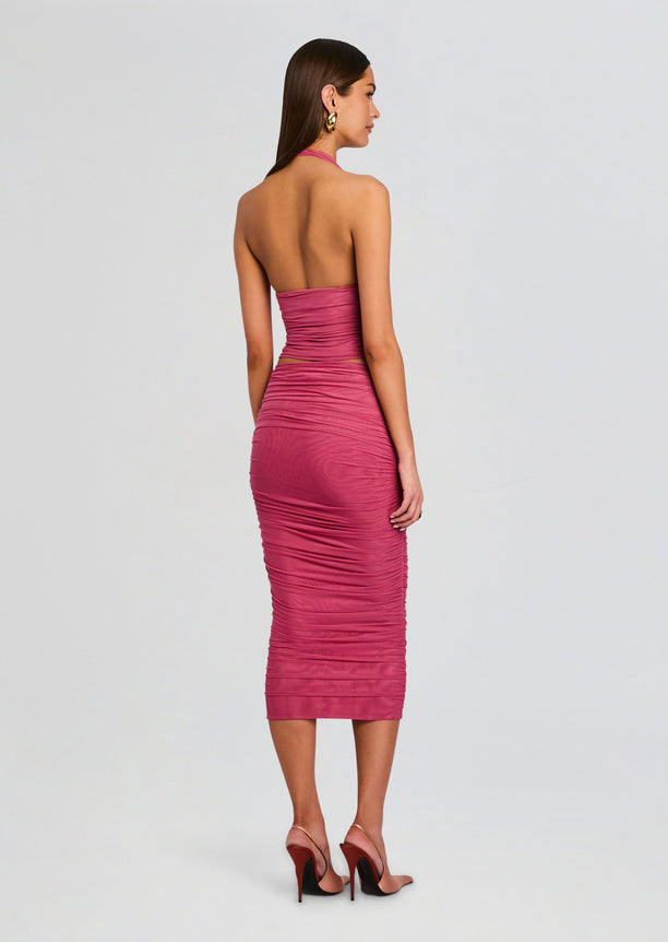Back view of the model in the pink Pia Mesh Midi Skirt with heels.
