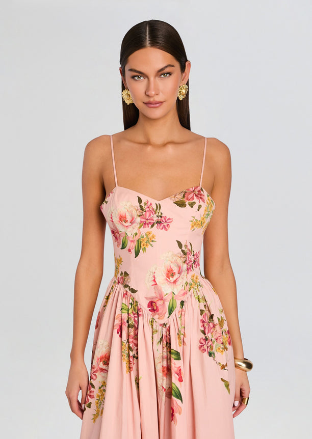 Front view of pink floral Ayla Corseted Midi Dress on model with slender straps and sweetheart neckline.