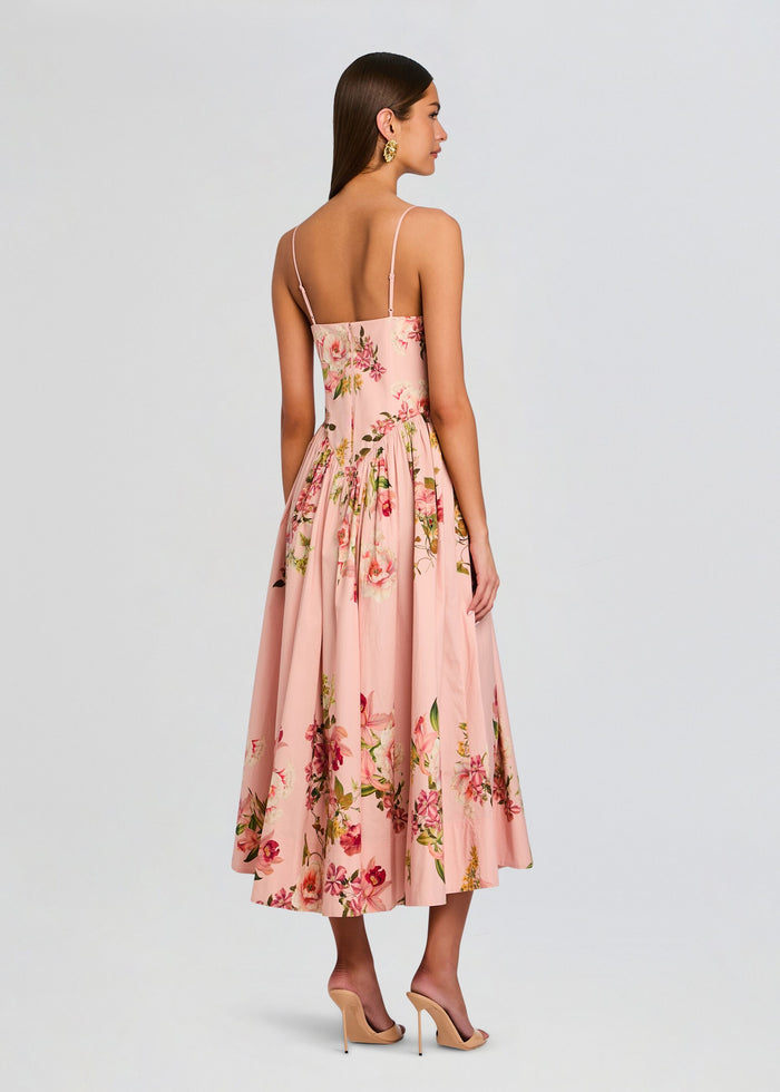 Back view of blush pink Ayla Corseted Midi Dress with floral print and slim straps on a model. media 4 of 5