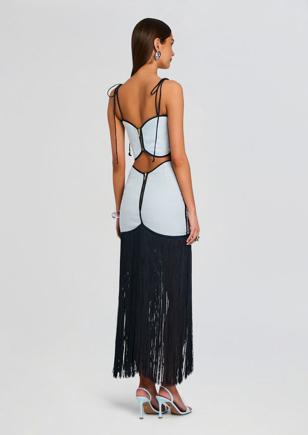 Back view of Joelle Skirt on model with light blue panels and a long black fringe hem