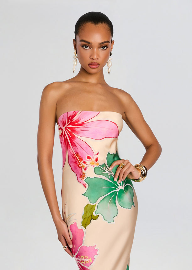Front portrait of a model in a strapless Keaton Silk Dress with vivid pink hibiscus print.