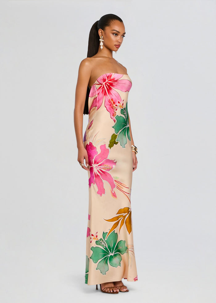 Full-length shot of a model in a strapless Keaton Silk Dress with a bold pink hibiscus print. media 5 of 6