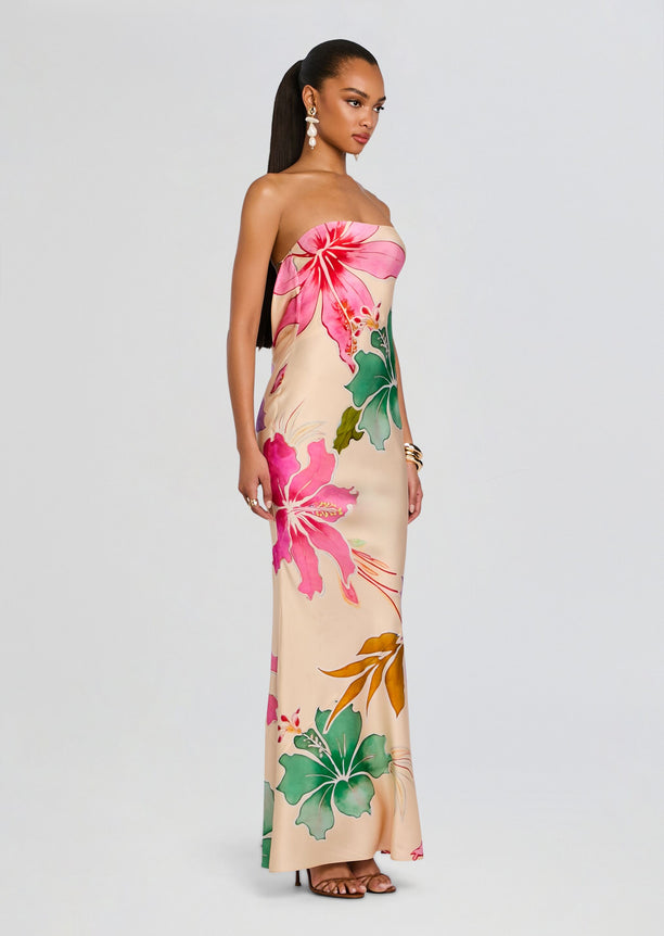 Full-length shot of a model in a strapless Keaton Silk Dress with a bold pink hibiscus print.