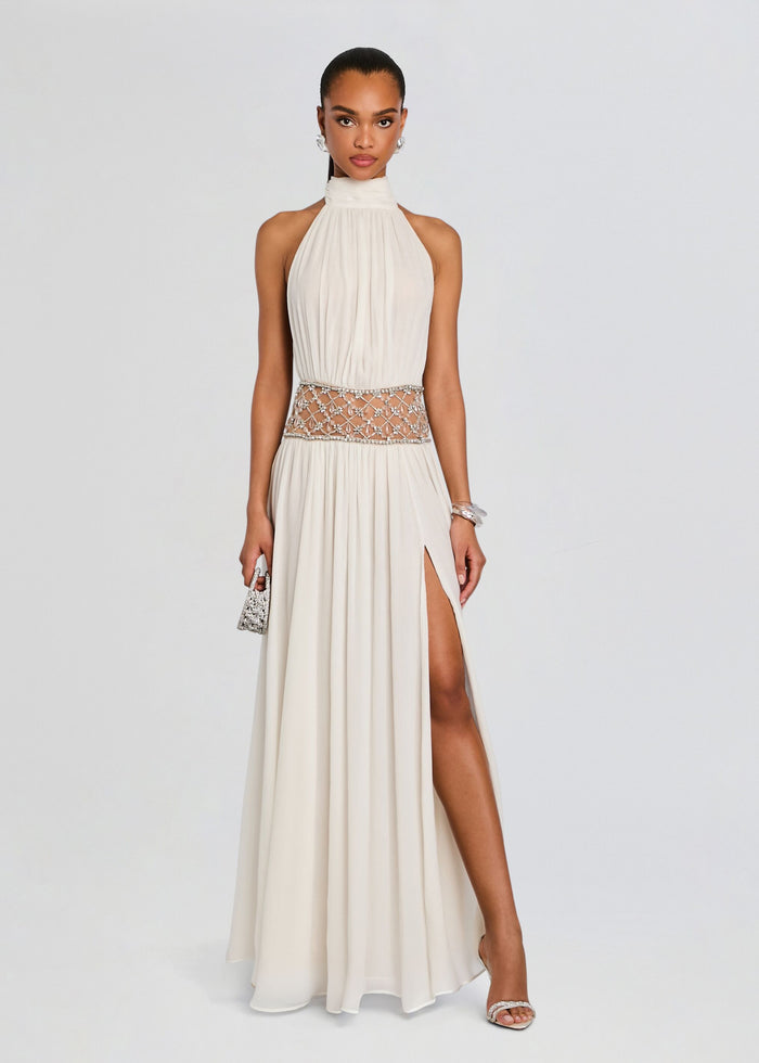 Full-length ivory Kreeli Embellished Dress with a pleated halter bodice, jeweled waist belt, and thigh-high slit. media 1 of 5